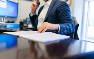 Trustee reviewing records while speaking by telephone